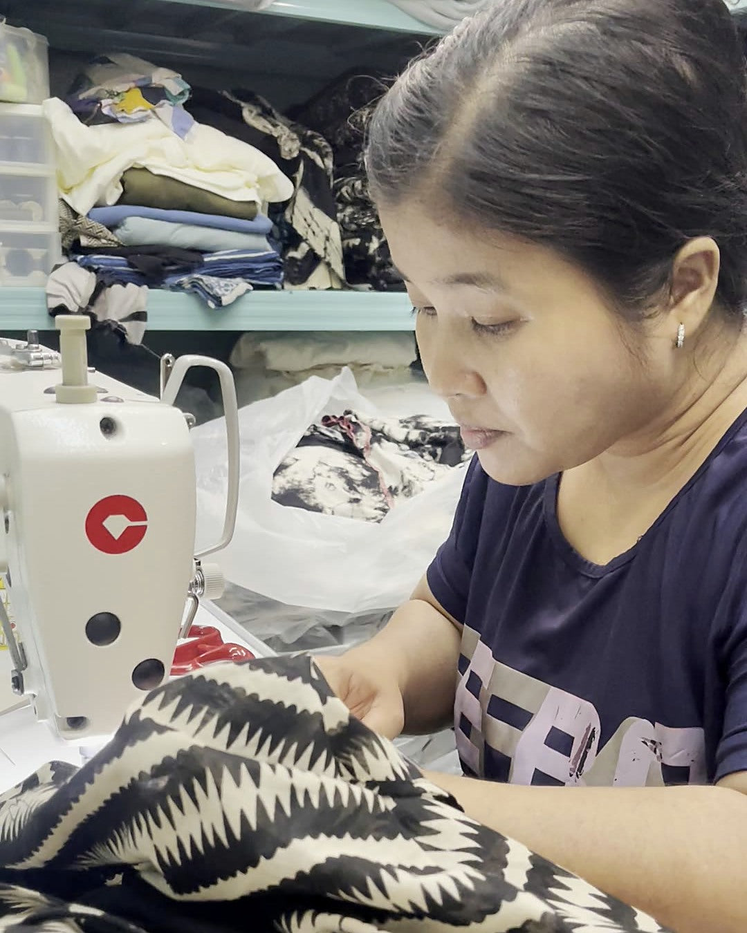 A seamstress at her machine in the Best Plan No Plan atelier, Koh Phangan