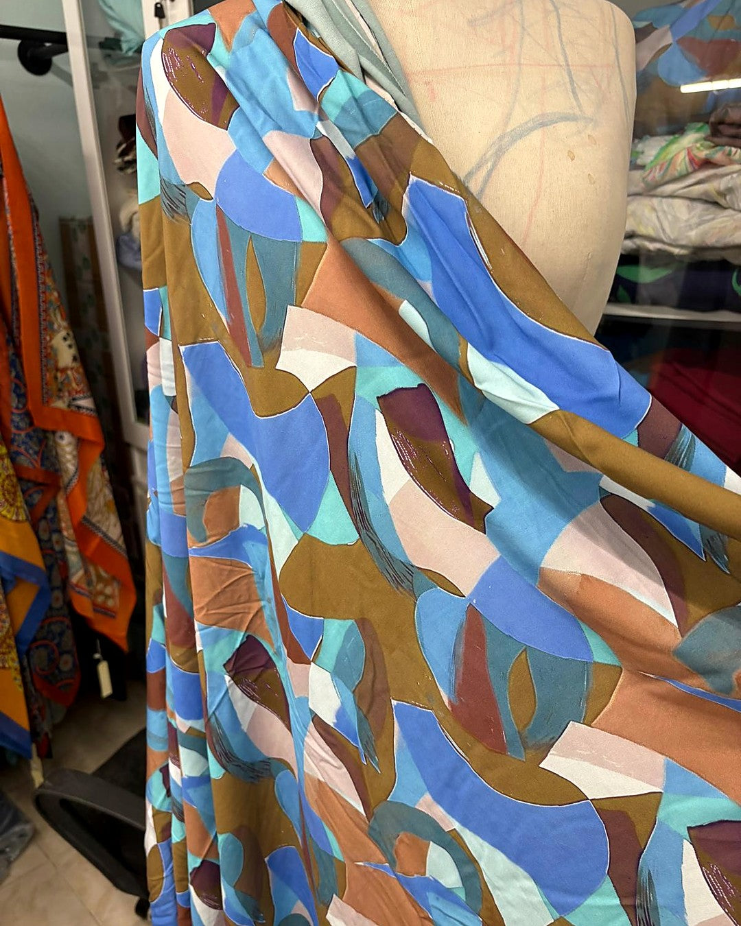 Hand-printed fabric draped on a dress form in the atelier